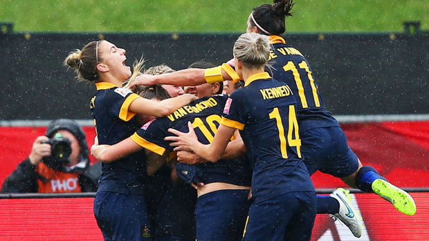 Steph Catley celebrates a goal with her Matildas teammates.