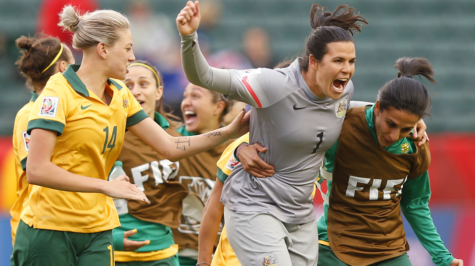 Lydia Williams celebrates with teammates after the Matildas qualify for the round of 16.