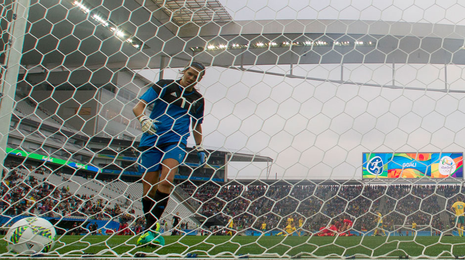 Lydia Williams pulls the ball out of the net after Canada's second goal.