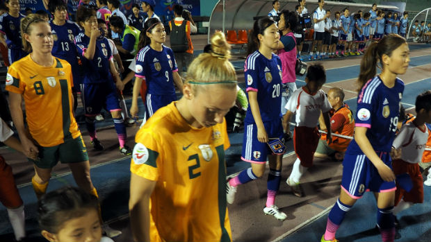 The Matildas and Japan walk out for the 2014 Women's Asian Cup final.2