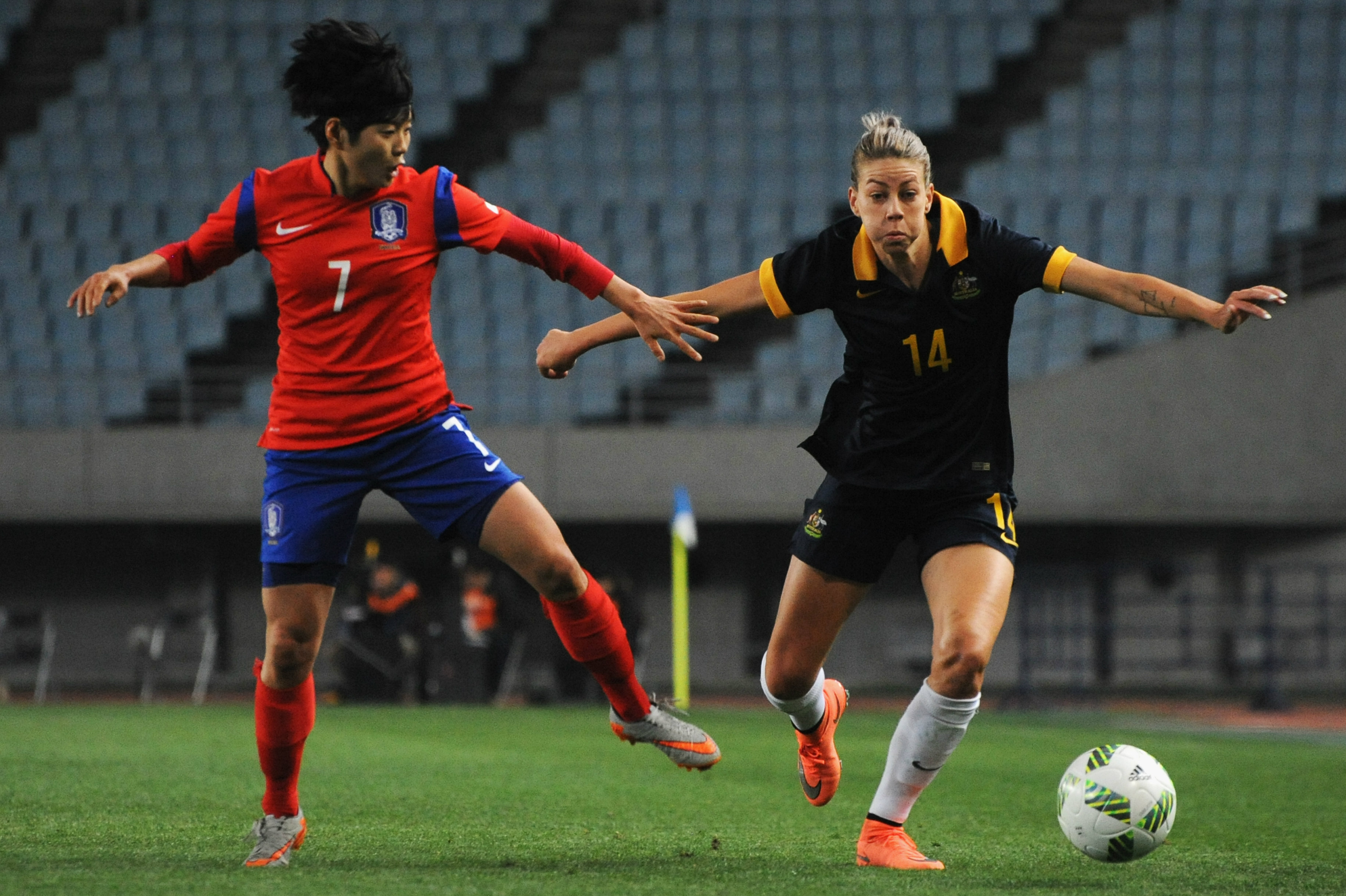 Alanna Kennedy holds off her Korea Republic opponent in their Olympic qualifier in 2016.