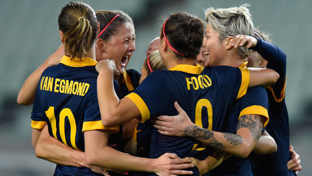 Matildas players celebrate a goal during the Olympic qualifiers in Japan.