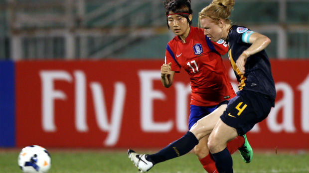 Westfield Matildas co-captain Clare Polkinghorne passes the ball against Korea Republic at the 2014 AFC Women's Asian Cup.